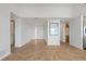 Open-concept living room with neutral walls, tile flooring, and access to kitchen and other rooms at 101 N Marion Ct # 133, Punta Gorda, FL 33950