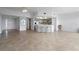 Spacious open-concept with tiled flooring, kitchen with bar seating, and access to outdoor balcony area at 101 N Marion Ct # 133, Punta Gorda, FL 33950