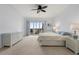 Spacious bedroom has plush carpet, ensuite bathroom, and balcony access with view at 101 N Marion Ct # 133, Punta Gorda, FL 33950