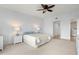Well-lit bedroom features plush carpet, ceiling fan, ensuite bathroom, and plenty of closet space at 101 N Marion Ct # 133, Punta Gorda, FL 33950