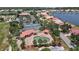 Community aerial view of tennis courts and pool with a golf course and lakes in the background at 10263 Shadow Run Cir, Punta Gorda, FL 33955