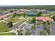 Panoramic aerial view showcases golf course, lakes, and the community clubhouse with a parking area at 10263 Shadow Run Cir, Punta Gorda, FL 33955