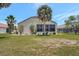 Backyard view of the home featuring a covered patio and well maintained yard at 10263 Shadow Run Cir, Punta Gorda, FL 33955