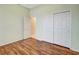Bedroom with hardwood flooring, neutral walls, and a closet with sliding doors at 10263 Shadow Run Cir, Punta Gorda, FL 33955