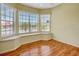Bedroom with window seating area, hardwood flooring, and a ceiling fan at 10263 Shadow Run Cir, Punta Gorda, FL 33955