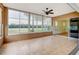 Enclosed lanai with tile flooring, ceiling fan, and large windows overlooking the yard at 10263 Shadow Run Cir, Punta Gorda, FL 33955