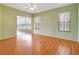 View of open living room with light green walls, wood floors, and lanai access at 10263 Shadow Run Cir, Punta Gorda, FL 33955
