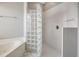 Luxurious main bathroom features a glass block shower and soaking tub at 10263 Shadow Run Cir, Punta Gorda, FL 33955