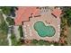 Aerial view showing a unique clover-shaped pool with lounge seating surrounded by tropical landscaping at 10263 Shadow Run Cir, Punta Gorda, FL 33955