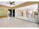 An open sunroom space with tile flooring and seamless access to the kitchen and living areas at 10263 Shadow Run Cir, Punta Gorda, FL 33955