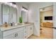 Bathroom featuring dual sinks with granite countertops and large mirrors at 122 Arrow Ln, Rotonda West, FL 33947
