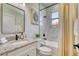 Well-lit bathroom featuring granite counters, modern fixtures, and a tiled shower-tub combination at 122 Arrow Ln, Rotonda West, FL 33947