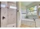 Modern bathroom showcasing a walk-in shower and soaking tub with natural light at 122 Arrow Ln, Rotonda West, FL 33947