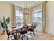 Well lit dining room with stylish chandelier and a view of the outdoors at 122 Arrow Ln, Rotonda West, FL 33947