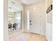 Entry way featuring a white front door and access to the dining room at 122 Arrow Ln, Rotonda West, FL 33947