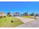 Charming single-story home with well-manicured lawn, long driveway, and a two car garage at 122 Arrow Ln, Rotonda West, FL 33947