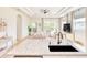 Open-concept kitchen with stone countertops and stainless steel appliances overlooking living area at 122 Arrow Ln, Rotonda West, FL 33947