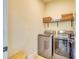 Clean and functional laundry room with stainless steel appliances, shelving, and ample storage space at 122 Arrow Ln, Rotonda West, FL 33947