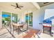 Outdoor patio with ceiling fan, dining table, and large sliding glass doors to indoor living spaces at 122 Arrow Ln, Rotonda West, FL 33947