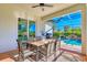 Covered outdoor dining area offers a view of the pool, palm trees, and screened-in patio at 122 Arrow Ln, Rotonda West, FL 33947