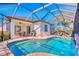 Inviting screened-in pool area with lounge chairs and dining space for outdoor enjoyment at 122 Arrow Ln, Rotonda West, FL 33947