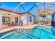 Enclosed pool area with lounge chairs and an outdoor dining area, perfect for relaxation and entertaining at 122 Arrow Ln, Rotonda West, FL 33947