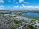 An aerial shot of a beautiful community with a pool, golf course, and clubhouse surrounded by trees and a lake at 14257 Heritage Landing Blvd # 1115, Punta Gorda, FL 33955