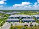 Stunning aerial view of a modern condo community with well-maintained landscaping and a picturesque lake at 14257 Heritage Landing Blvd # 1115, Punta Gorda, FL 33955