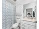 A stylish bathroom that boasts a modern vanity, complemented by a blue patterned shower curtain at 14257 Heritage Landing Blvd # 1115, Punta Gorda, FL 33955