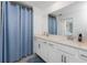Contemporary bathroom showcasing dual sinks with quartz countertops, accented by a stylish blue shower curtain at 14257 Heritage Landing Blvd # 1115, Punta Gorda, FL 33955
