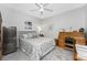 Comfortable bedroom featuring tiled floors, a ceiling fan, and a mini fridge, offering a serene retreat at 14257 Heritage Landing Blvd # 1115, Punta Gorda, FL 33955
