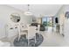 Open-concept dining area with a stylish table, elegant light fixture, and a comfortable living space at 14257 Heritage Landing Blvd # 1115, Punta Gorda, FL 33955