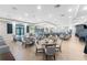 Large dining room featuring tables and chairs, a bar area, and elegant decor at 14257 Heritage Landing Blvd # 1115, Punta Gorda, FL 33955