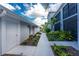 Inviting exterior view showcasing a beautifully landscaped walkway leading to a condo entrance at 14257 Heritage Landing Blvd # 1115, Punta Gorda, FL 33955