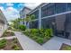 Charming exterior view of a condo building with lush greenery and a well-maintained walkway at 14257 Heritage Landing Blvd # 1115, Punta Gorda, FL 33955