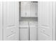 Convenient laundry closet with washer and dryer, enhanced by bright lighting and efficient storage at 14257 Heritage Landing Blvd # 1115, Punta Gorda, FL 33955