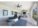 Comfortable outdoor patio with ceiling fans, fireplace, TV, and stylish furnishings at 14257 Heritage Landing Blvd # 1115, Punta Gorda, FL 33955