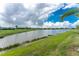 Scenic view overlooking a tranquil pond, reflecting the clear blue sky and surrounding lush greenery at 14257 Heritage Landing Blvd # 1115, Punta Gorda, FL 33955