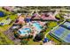 A breathtaking aerial view shows the clubhouse, pools, tennis courts and beautiful landscaping at 1470 Hyssop Loop, North Port, FL 34289