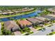 Waterfront home with a red tile roof, a two-car garage, and lush landscaping in a well-maintained community at 1470 Hyssop Loop, North Port, FL 34289