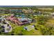 Overhead view showcases the community clubhouse with pool, tennis courts, and bocce ball courts at 1470 Hyssop Loop, North Port, FL 34289