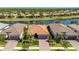 Beautiful home with red tile roof, two-car garage, and lush landscaping, positioned waterfront in a desirable community at 1470 Hyssop Loop, North Port, FL 34289