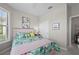 Comfortable bedroom with decorative pillows, closet, and beautiful floral decor at 1470 Hyssop Loop, North Port, FL 34289