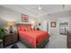 Inviting bedroom with a king-sized bed, neutral walls, and direct access to the bathroom at 1470 Hyssop Loop, North Port, FL 34289