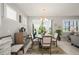 Charming dining area with a round wooden table, stylish chairs, and a view of the outdoors at 1470 Hyssop Loop, North Port, FL 34289