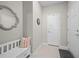A neutral entryway with bench seating, a decorative mirror, and interior doors to other rooms at 1470 Hyssop Loop, North Port, FL 34289