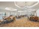 Spacious event room with abundant seating, overhead lighting, and large projector screen at 1470 Hyssop Loop, North Port, FL 34289