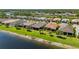This single-Gathering home boasts a spacious yard, tropical landscaping, and an idyllic lakeside setting at 1470 Hyssop Loop, North Port, FL 34289