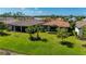 Beautiful landscaping and expansive lawn enhance the curb appeal of this home near the community lake at 1470 Hyssop Loop, North Port, FL 34289