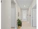 Inviting foyer with neutral walls, tile floors, and decorative plant leading to rooms at 1470 Hyssop Loop, North Port, FL 34289